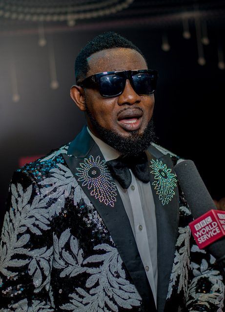 AY Makun in sunglasses and a sequinned jacket