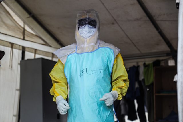 A health worker in a protective suit