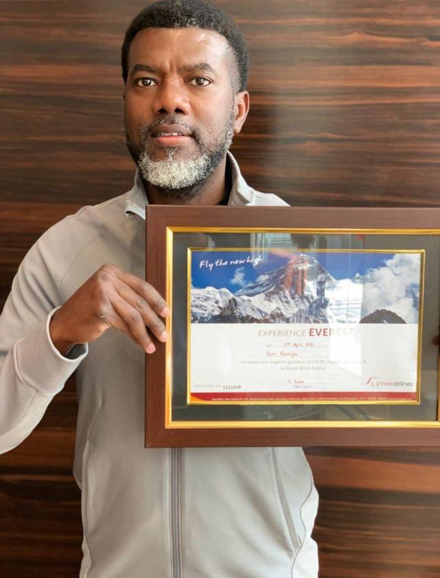 Reno Omokri holding a framed certificate